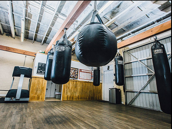 Flash gym Dynamic boxing interior with athletes sparring and training."